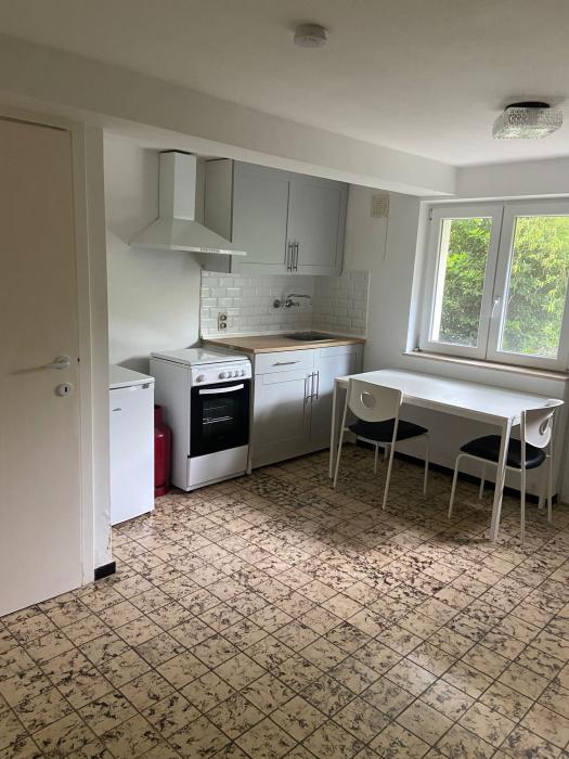 Coin cuisine avec table et 2 chaises + frigo + cuisinière